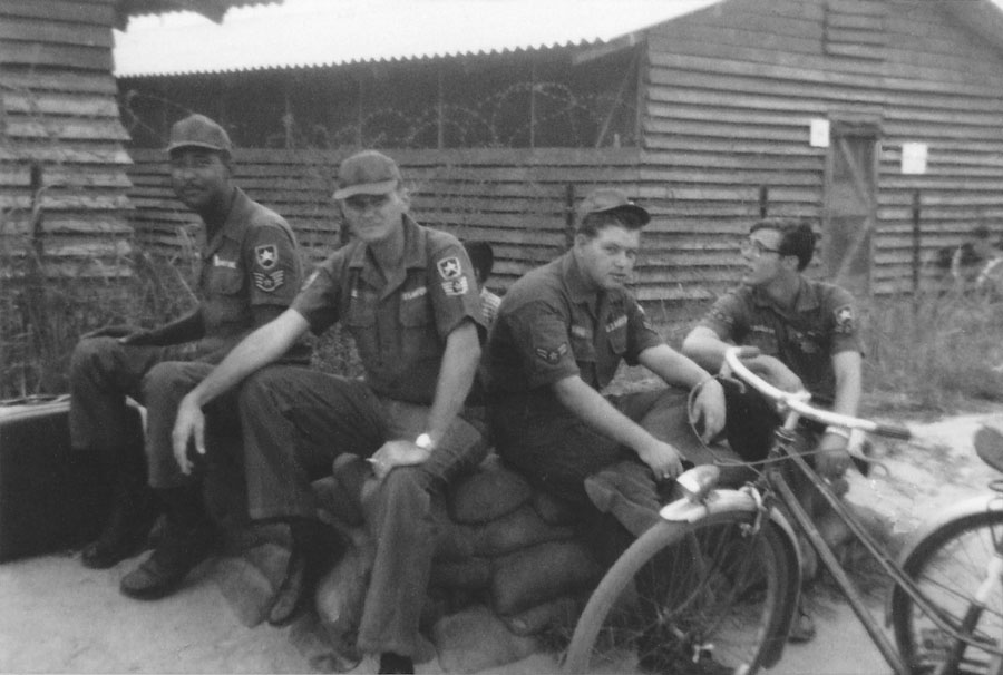 14. Da Nang AB: Off duty Air Police set on sandbags along road fronting huts. Across the street is ARVN housing, and a lot of young Vietnamese ladies walk near where they are setting. Photo: Second from right is A2C Richard Suggs. I think he is retired USAF and lives in North Dakota.